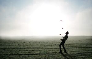 man juggling three balls